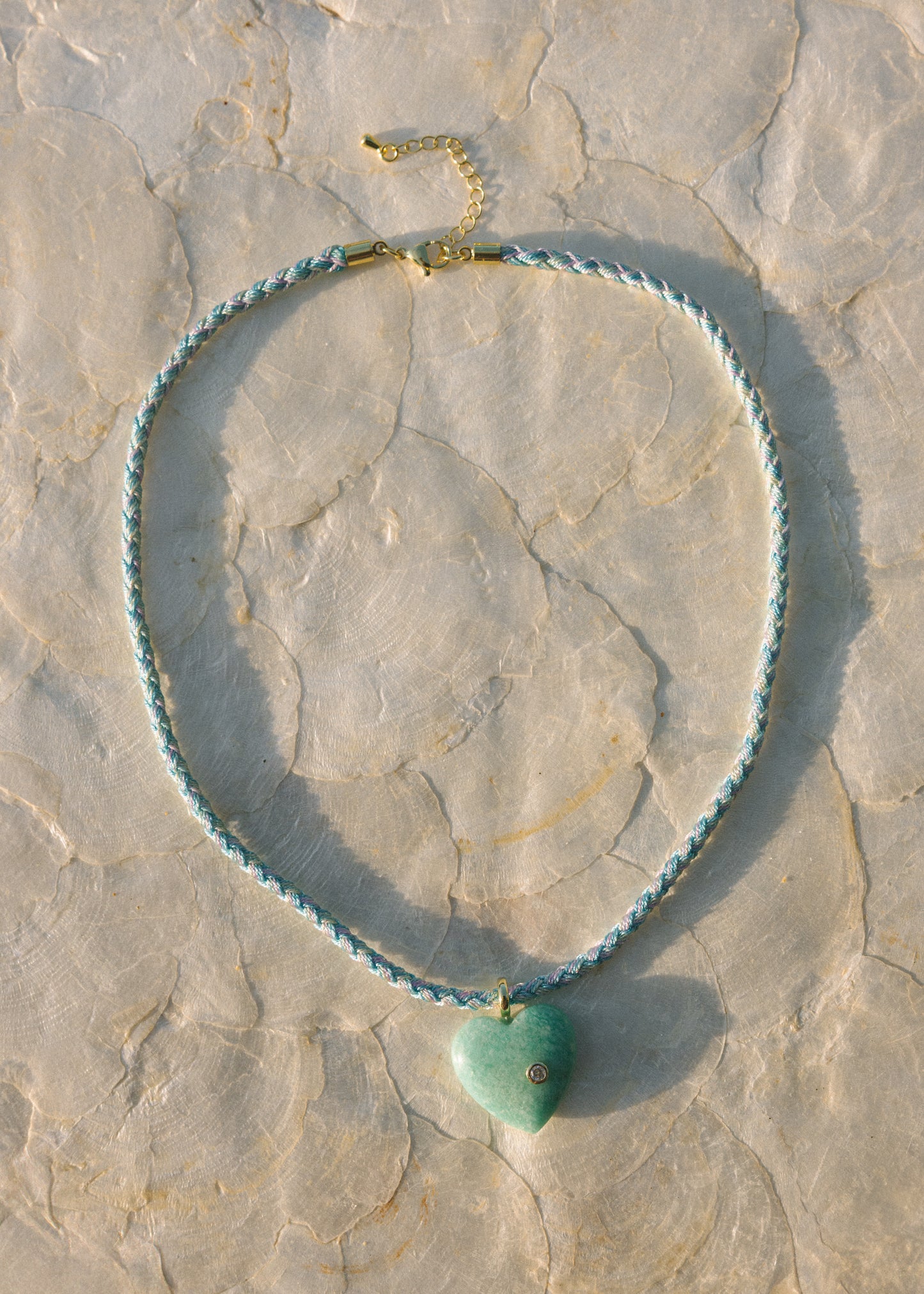 Necklace with a heart-shaped pendant on a stone surface