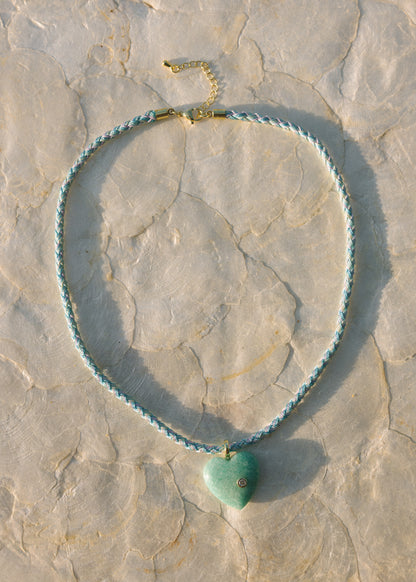 Necklace with a heart-shaped pendant on a stone surface
