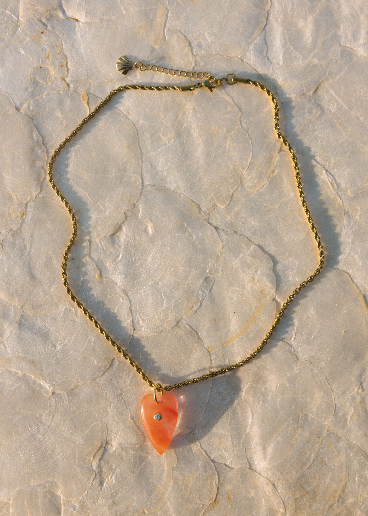 Necklace with a heart-shaped pendant on a stone surface
