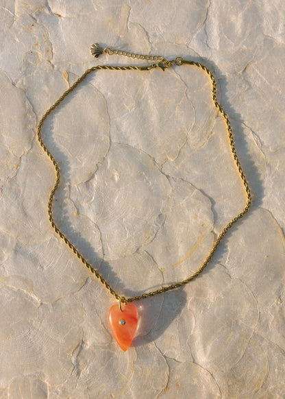 Necklace with a heart-shaped pendant on a stone surface