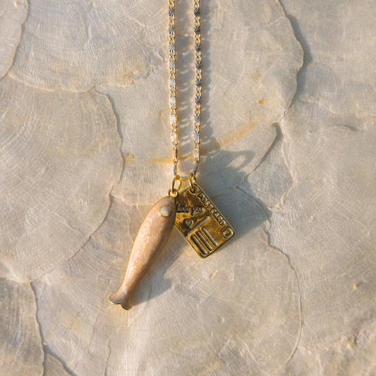 Necklace with a pendant on a textured stone surface