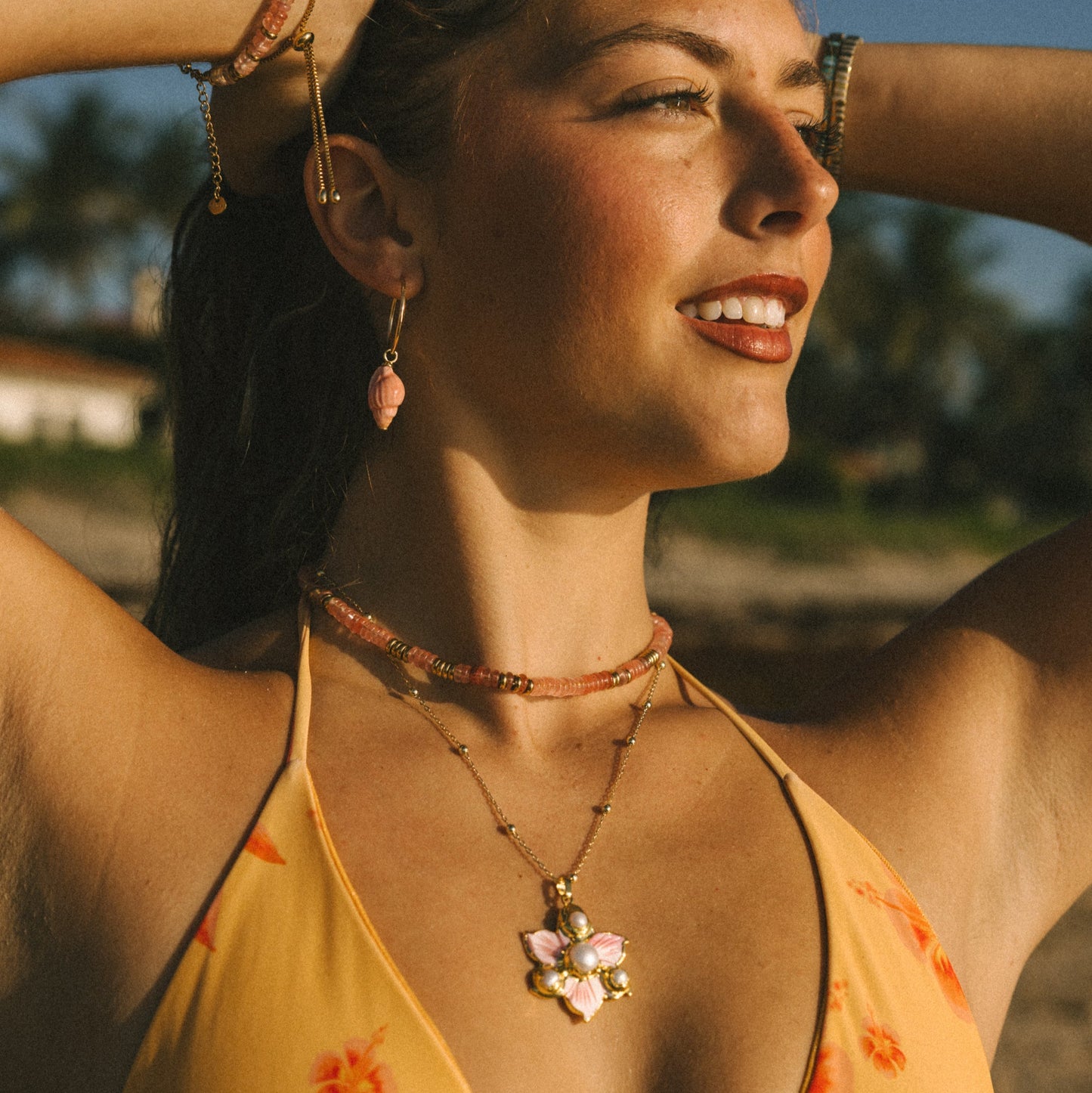 Woman wearing a yellow floral bikini with a blurred background