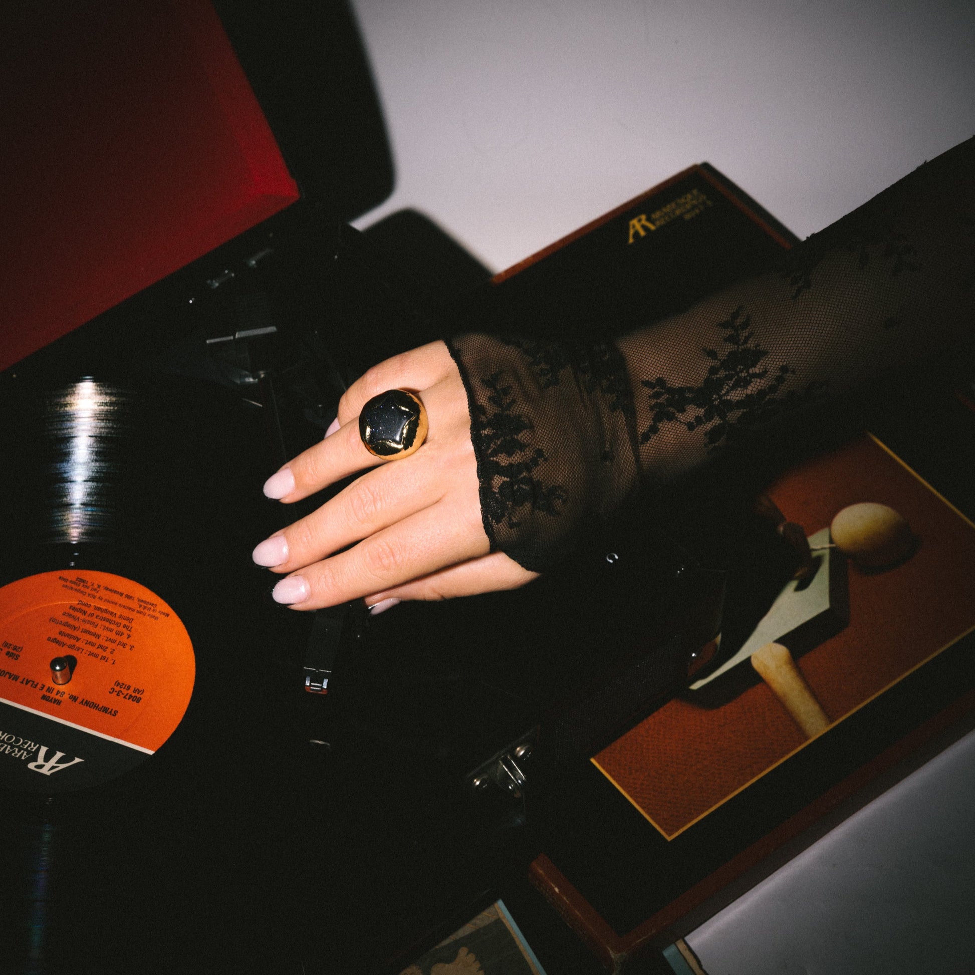 Hand holding a vinyl record with a dark background