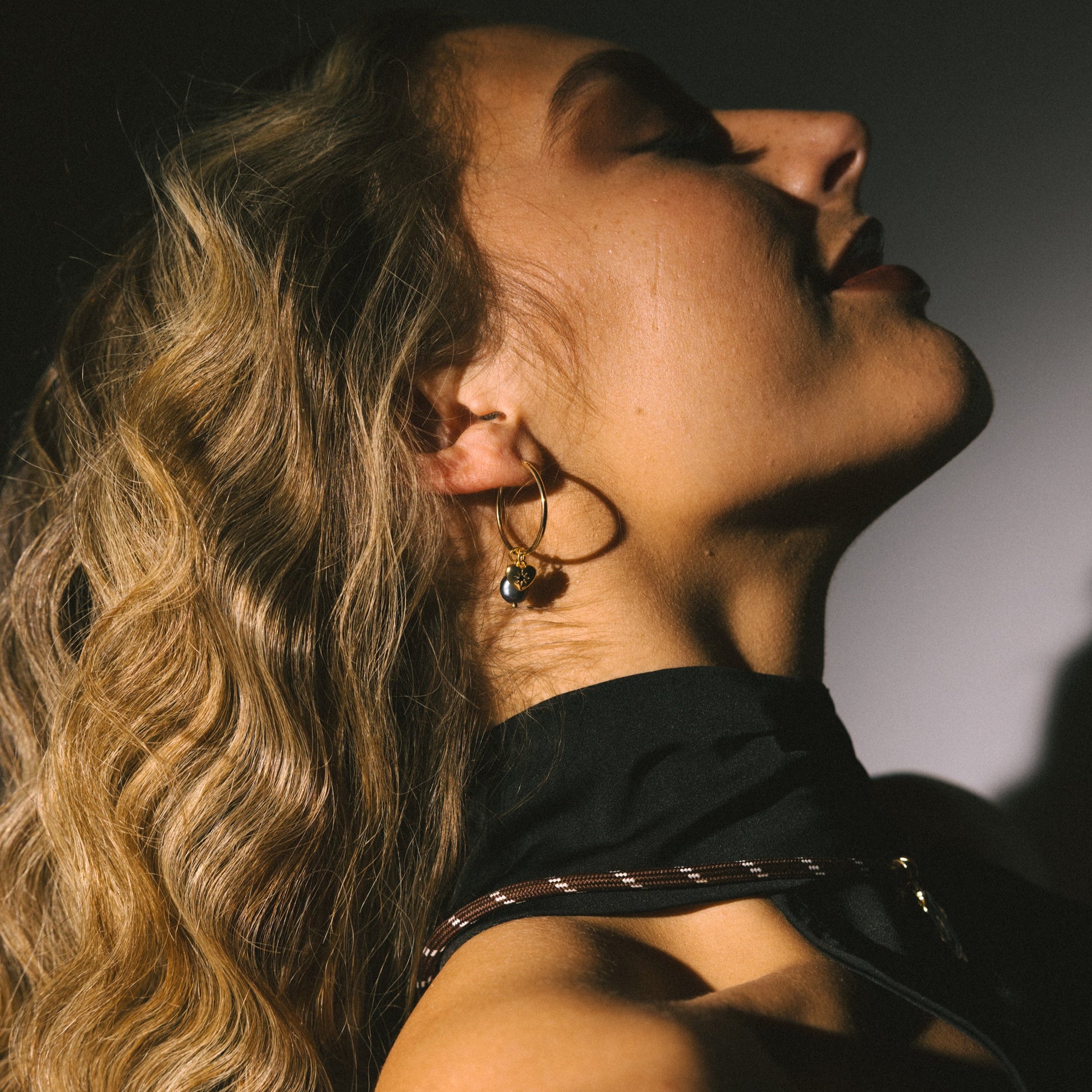 Two people embracing with a warm glow on a dark background