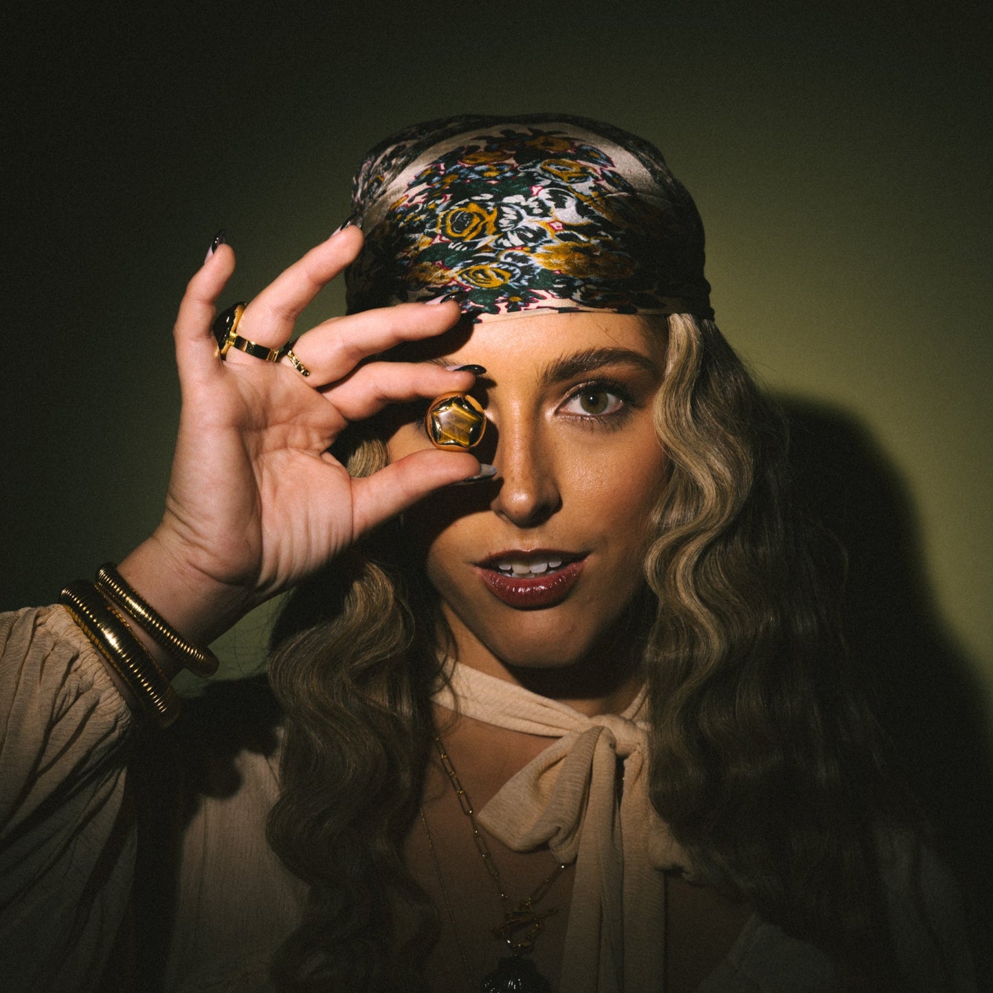 Person holding a crystal ball against a dark background